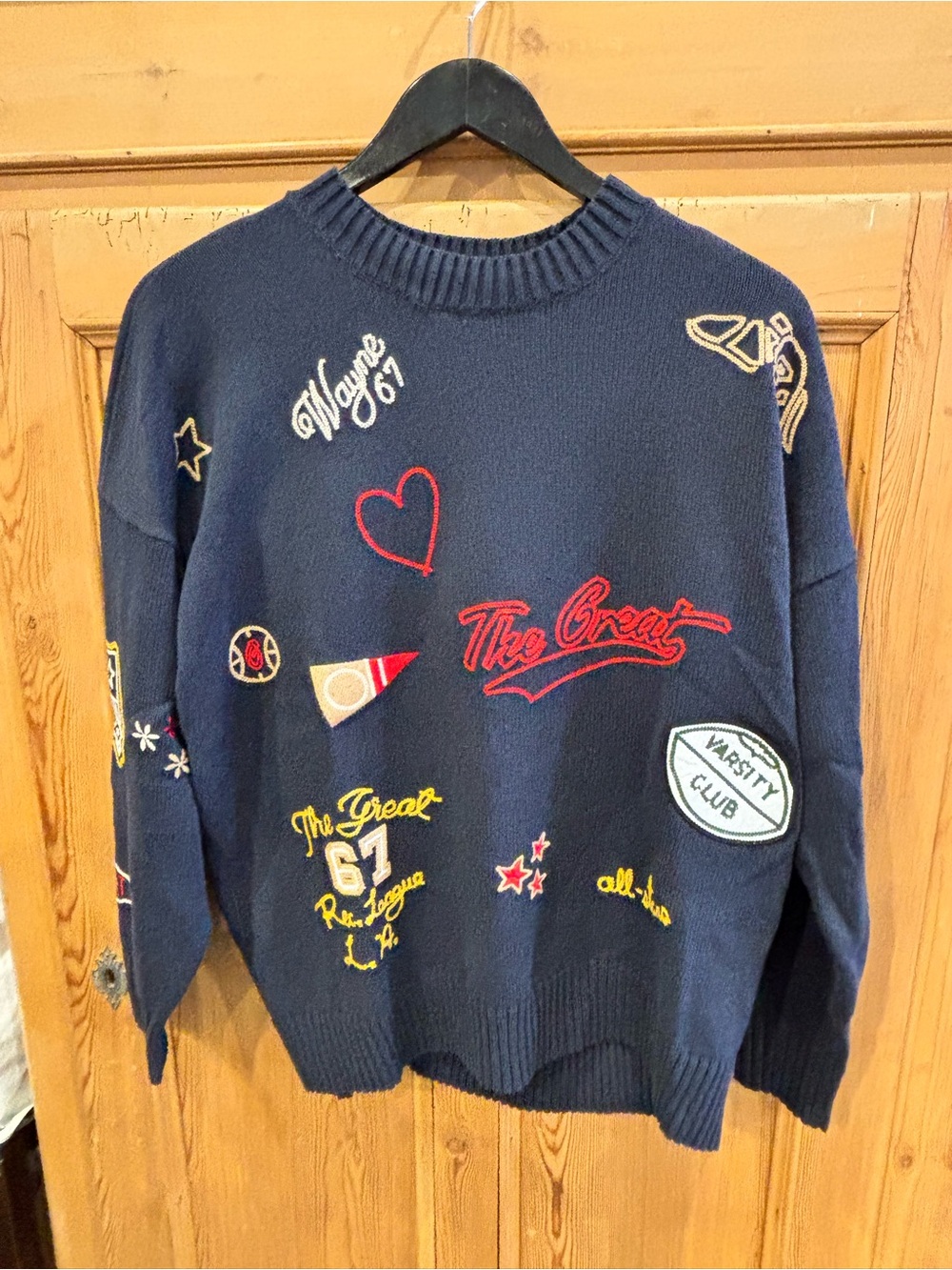 THE GREAT. Navy Crewneck Sweater with Red & Yellow Embroidered Patches